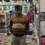 Business owner watching his store get looted